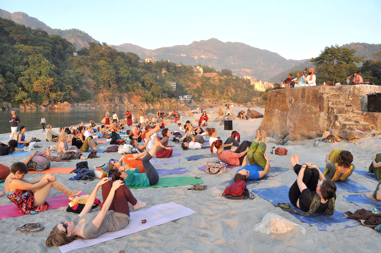women practicing yoga in rishikesh