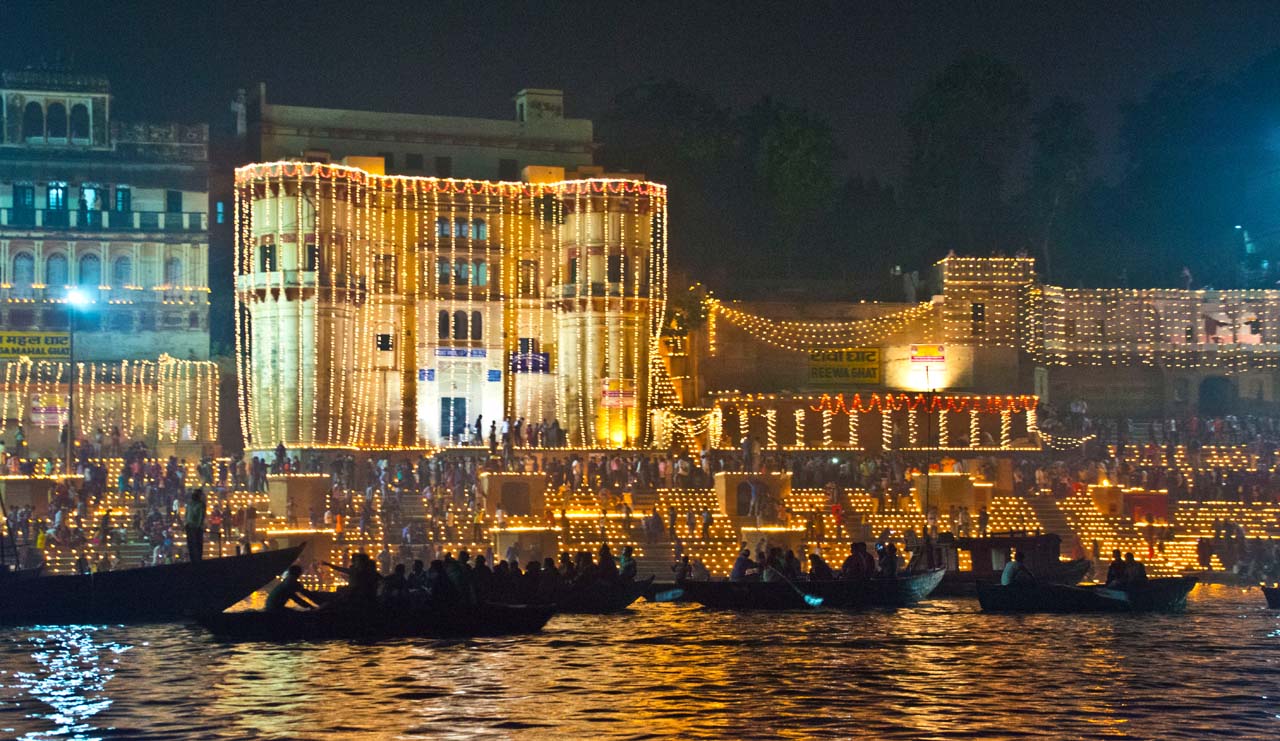 varanasi ghat decorated with divas during diwali