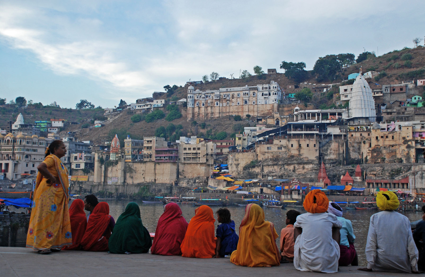 villagers siting beside river in madhya pradesh - places to visit in india before 30