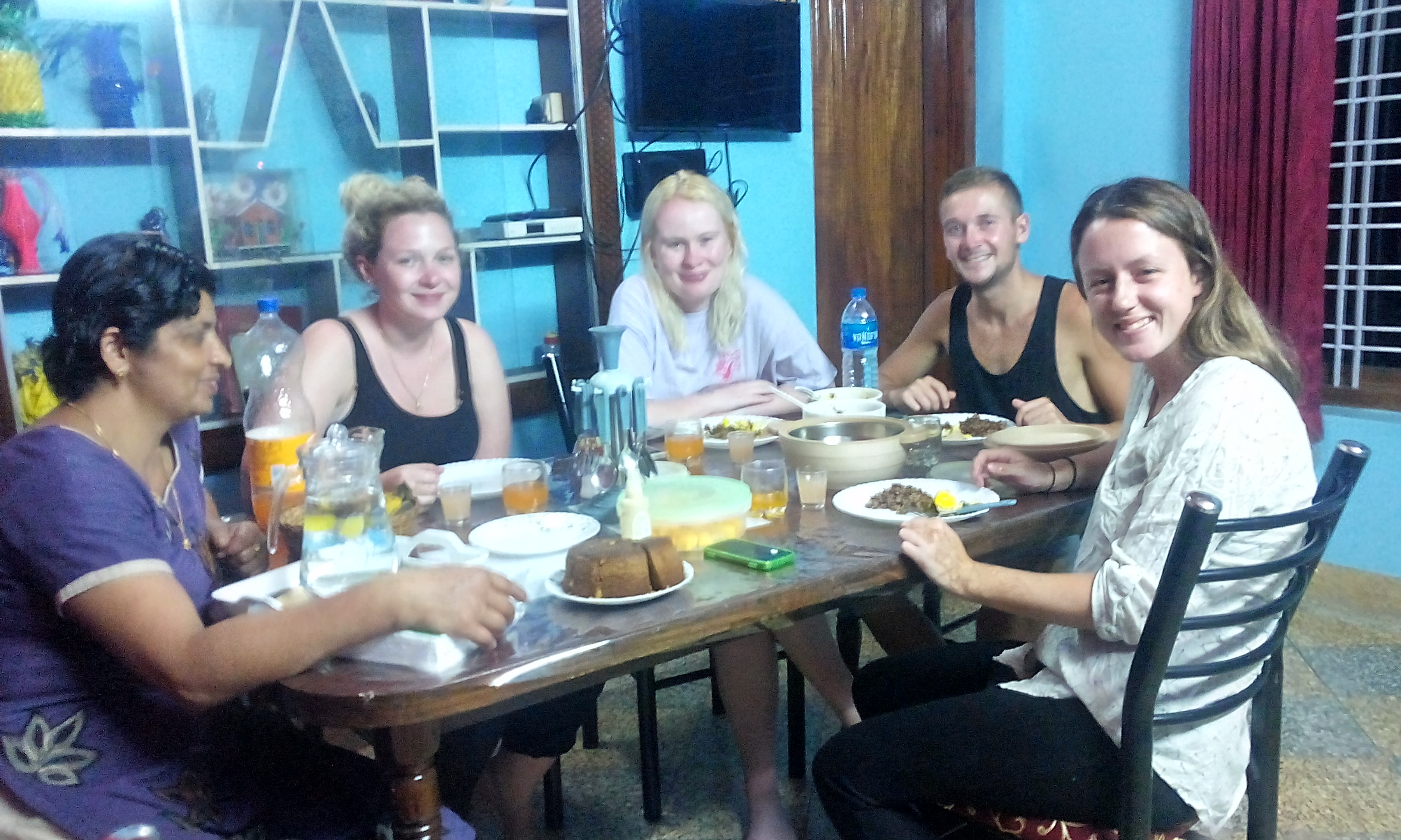 foreign guest having dinner at peppervilla - hilltop homestays in wayanad